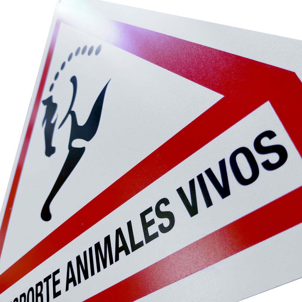 Placa de alerta branca com borda vermelha e texto TRANSPORTE ANIMALES VIVOS