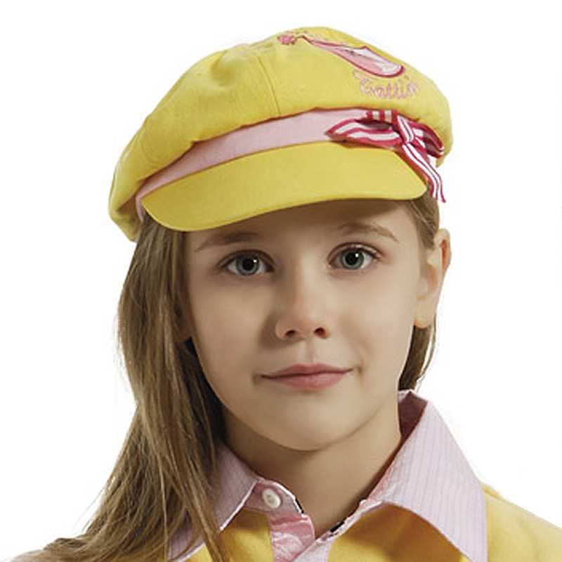 Criança com boina amarela, camisa rosa e colete amarelo