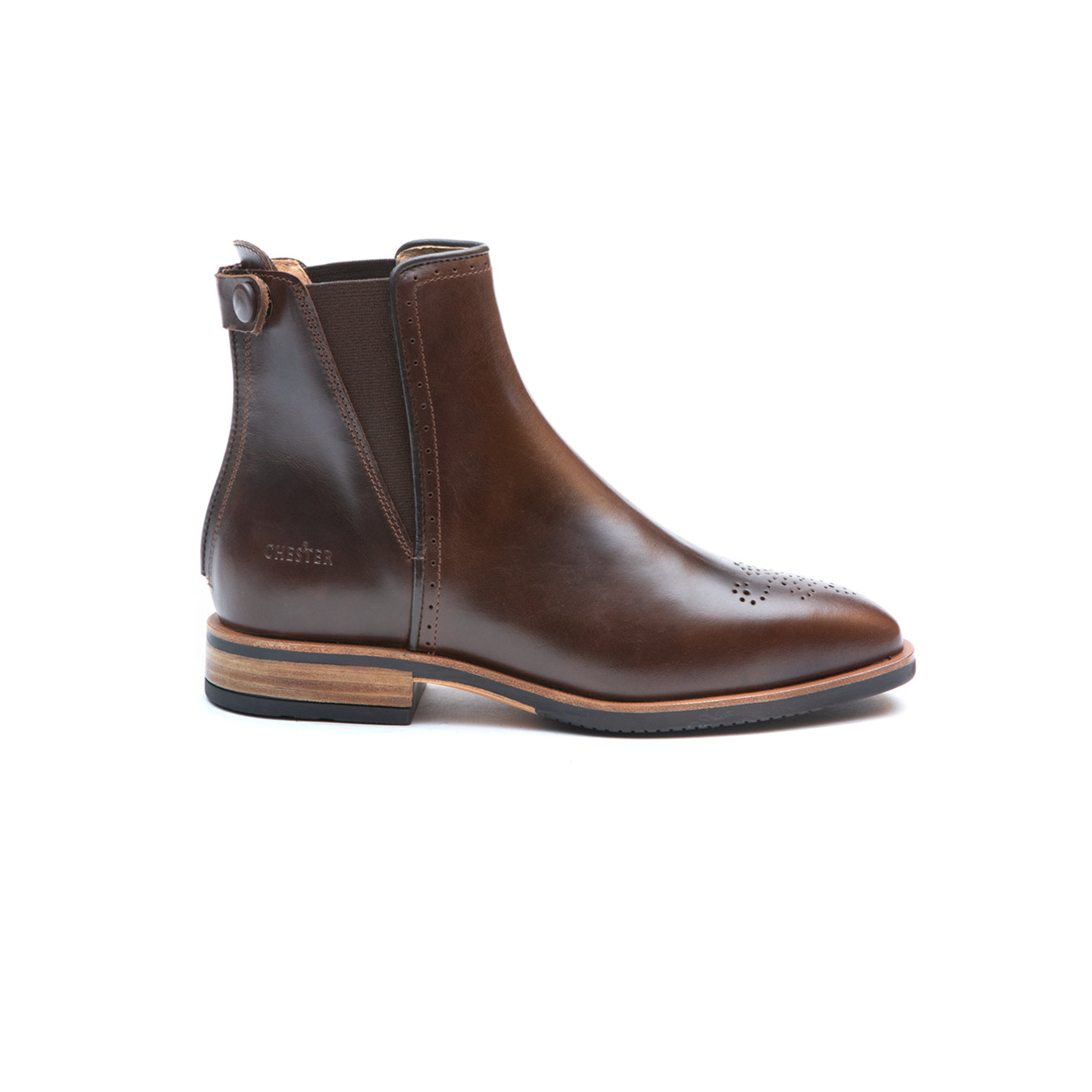 Bota castanha em pele com sola preta e detalhes em madeira, perforações decorativas e elásticos laterais