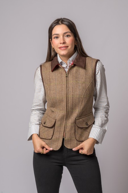 Mulher com colete castanho xadrez e camisa branca de quadrados