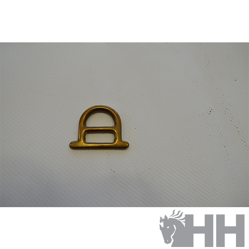 Peça metálica dourada em superfície branca texturada