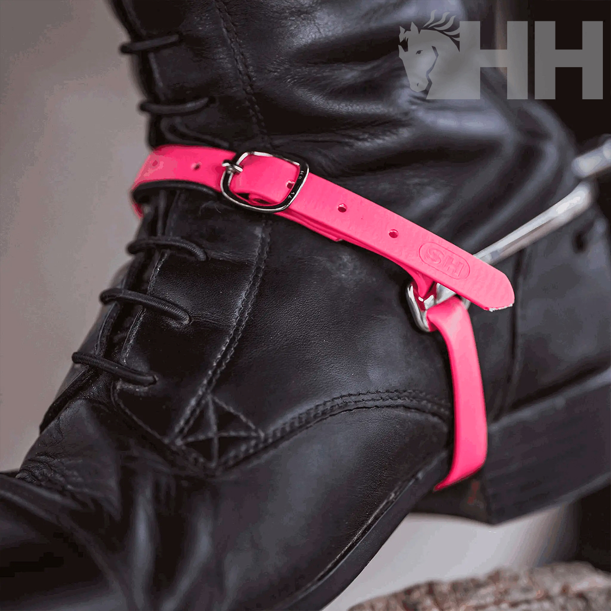 Bota preta de couro com correia cor-de-rosa e fivela metálica