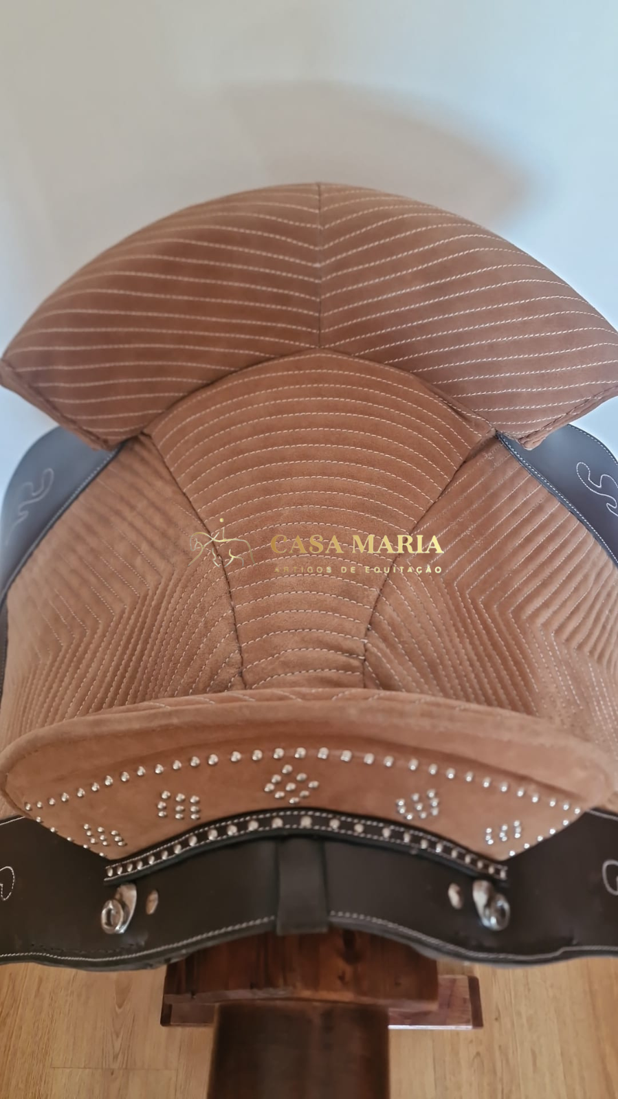 Sela de equitação castanha com detalhes em couro preto e tachas prateadas