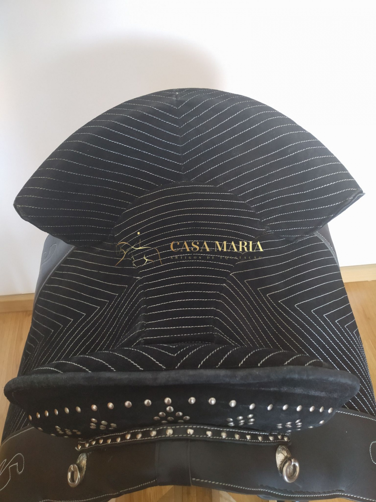 Sela de cavalo preta com padrões listrados brancos e texto 'CASA MARIA'