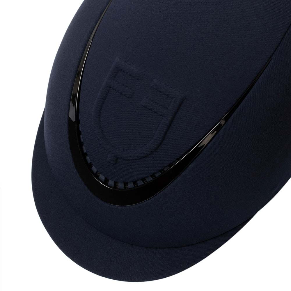 Capacete de equitação azul escuro com detalhe em relevo e acabamento preto brilhante.