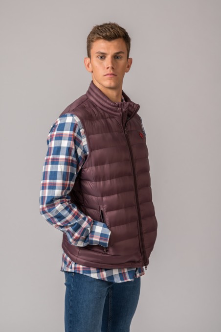 Colete acolchoado masculino castanho com camisa xadrez azul, branca e vermelha e calças de ganga