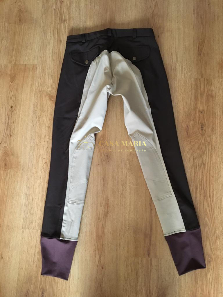 Calças de equitação bicolor colocadas no chão de madeira