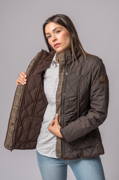 Casaco acolchoado castanho com padrão losangos usado por mulher