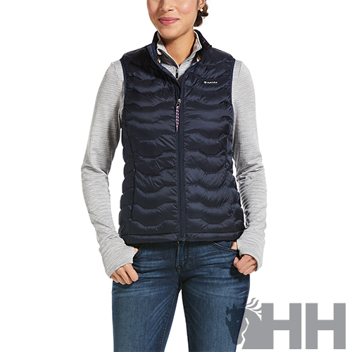 Colete acolchoado azul-marinho para mulher com fecho de correr, usado sobre camisola cinzenta de manga comprida