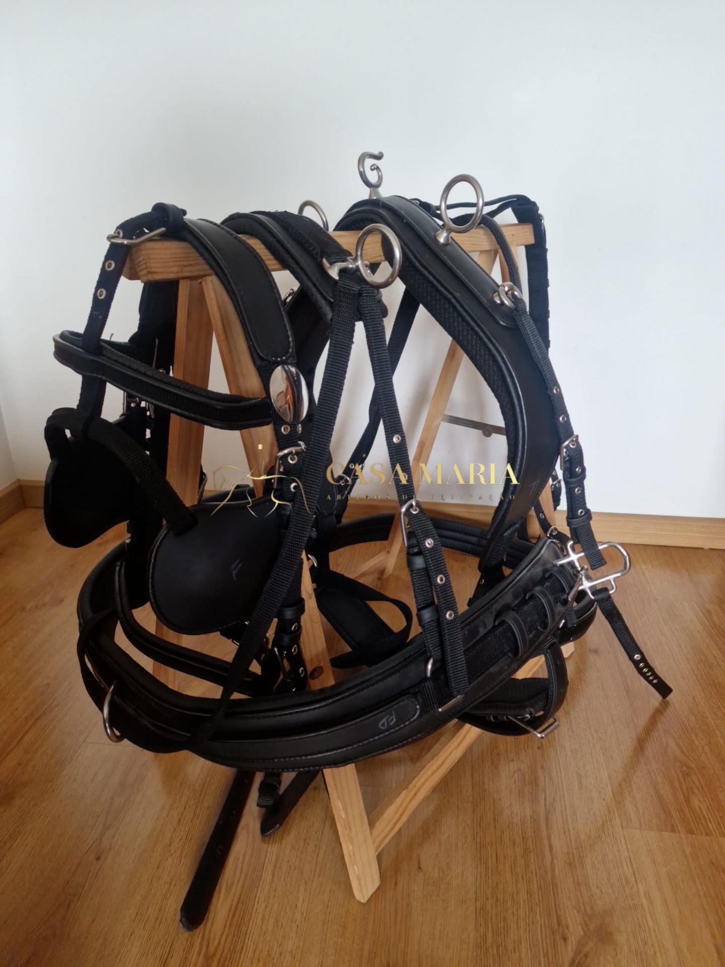 Peitoral de cavalo preto em nylon com acolchoamento sobre suporte de madeira