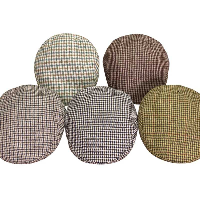 Cinco boinas com padrão pied-de-poule de várias cores sobre fundo branco