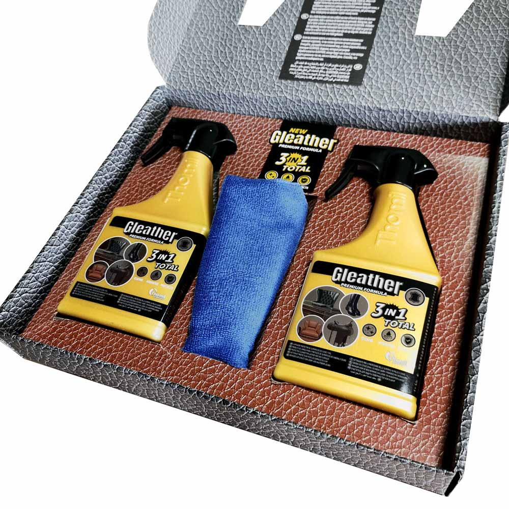 Conjunto com dois sprays amarelos Gleather 3 in 1 Total e um pano azul dentro de caixa com textura de couro