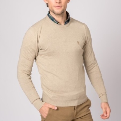 Homem com camisola bege de malha e calças castanhas