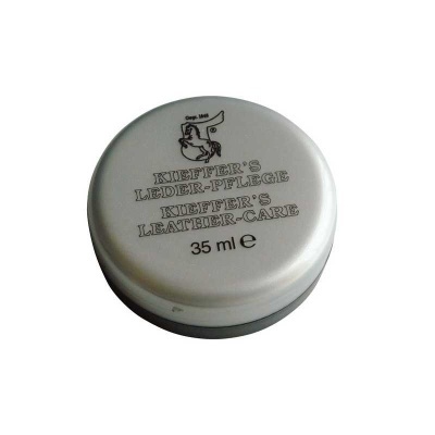 Contentor metálico prateado redondo para cuidado de couro com texto preto