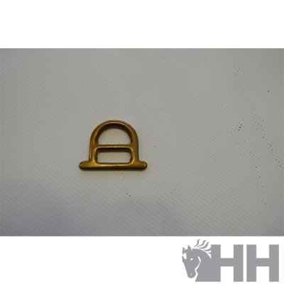 Peça metálica dourada em superfície branca texturada