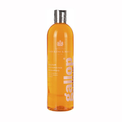 Garrafa de shampoo transparente laranja com tampa prateada e texto branco