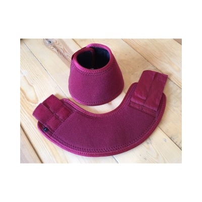 Conjunto de proteção em material vinílico cor rubi com velcro sobre superfície em madeira clara