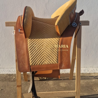 Sela de equitação bege e castanha com textura acolchoada e detalhes em couro