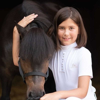 Rapariga de camisa branca e cavalo castanho escuro com focinheira preta