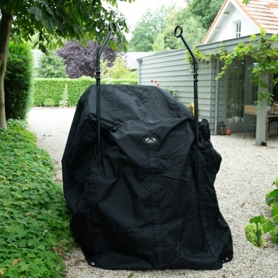 Cobertura preta para grelhador exterior junto a vegetação e casa