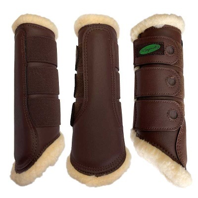 Proteções castanhas para equitação com interior de pêlo creme e fecho de velcro ou fivelas