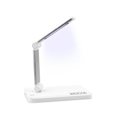 Lâmpada de mesa branca e prateada com luz LED azulada e base com texto INOCOS