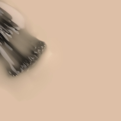 Objeto metálico preto desfocado em fundo bege