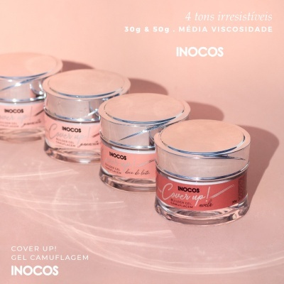 Frascos de gel de unhas INOCOS com tampas prateadas e etiquetas em tons de rosa sobre fundo rosa com texto branco.
