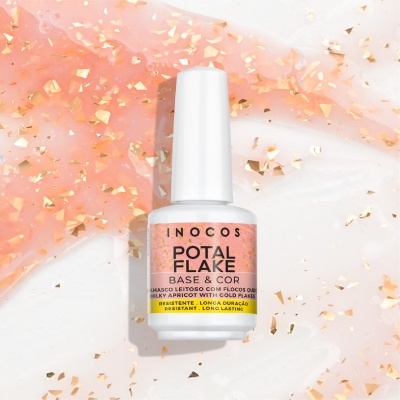 Frasco de verniz branco INOCOS POTAL FLAKE sobre fundo rosa com flocos dourados
