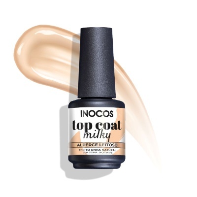 Frasco de verniz Inocos top coat milky com tampa preta sobre fundo branco e mancha bege
