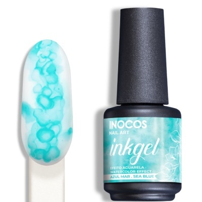 Frasco de verniz azul mar da INOCOS com amostra de unhas dessign irisado