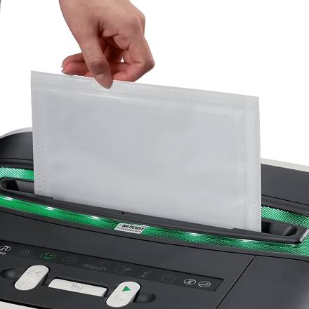 Máquina de plastificação preta com detalhes verdes metálicos e plástico transparente a ser inserido