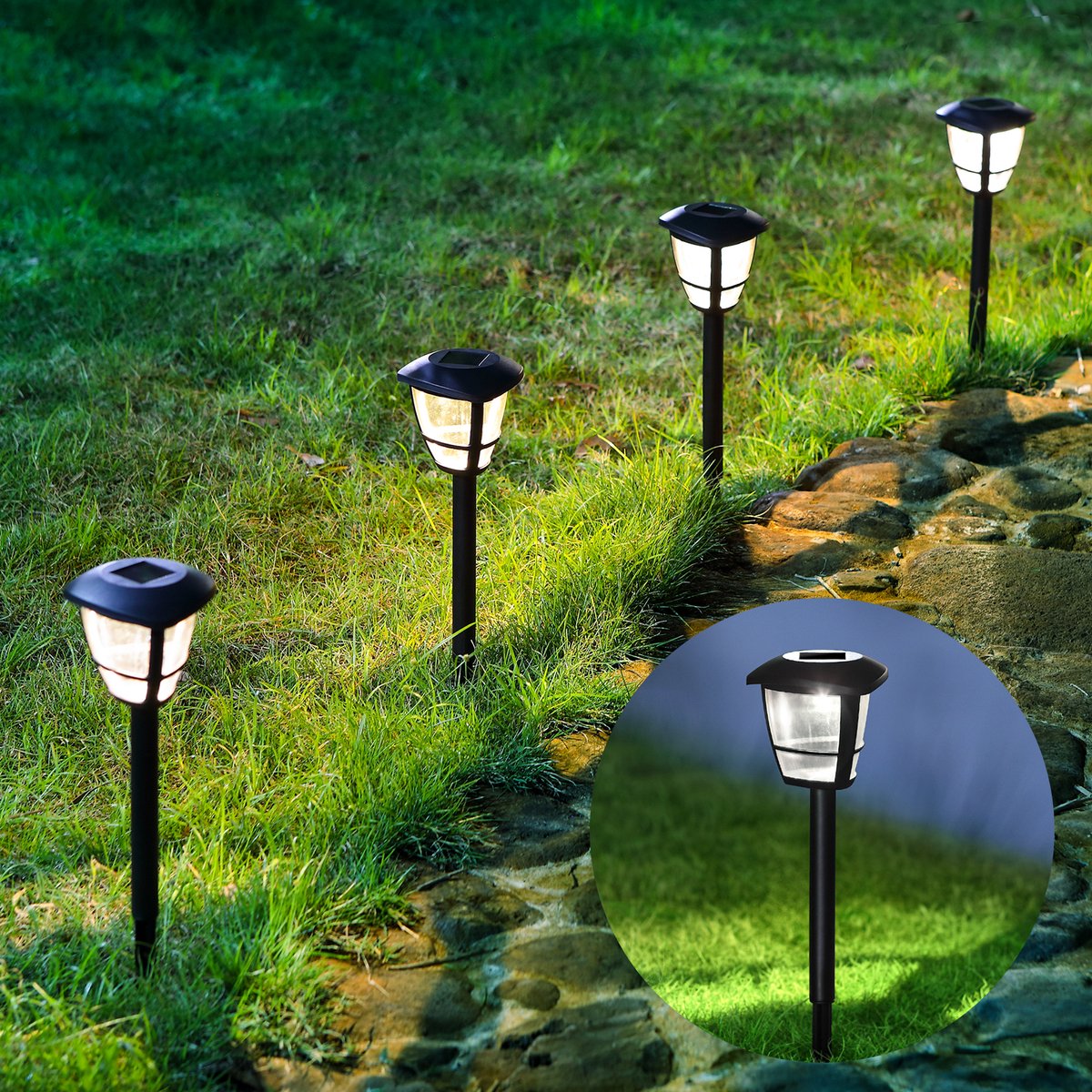 Lâmpadas de jardim solares pretas iluminadas em relva junto a caminho de pedra