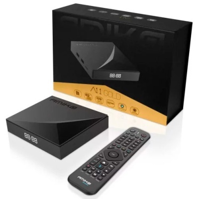 TV box preto com comando remoto e embalagem preta e dourada