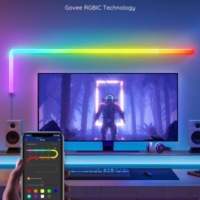 Setup de computador com iluminação LED RGB multicolor e monitor com imagem de astronauta
