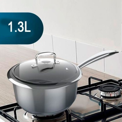 Panela de inox com tampa de vidro sobre fogão a gás