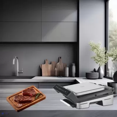 Bancada de cozinha com bifes grelhados e sandwichera eléctrica