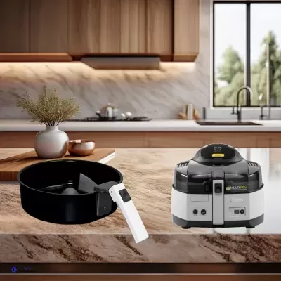 Frigideira preta com cabo branco e fritadeira elétrica preta e branca sobre bancada de cozinha