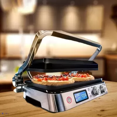 Grill elétrico inox com tampa aberta cozinhando pizza sobre bancada de madeira