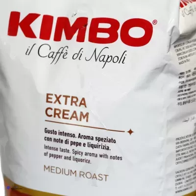 Pacote branco de café Kimbo Extra Cream Medium Roast com texto em vermelho e castanho