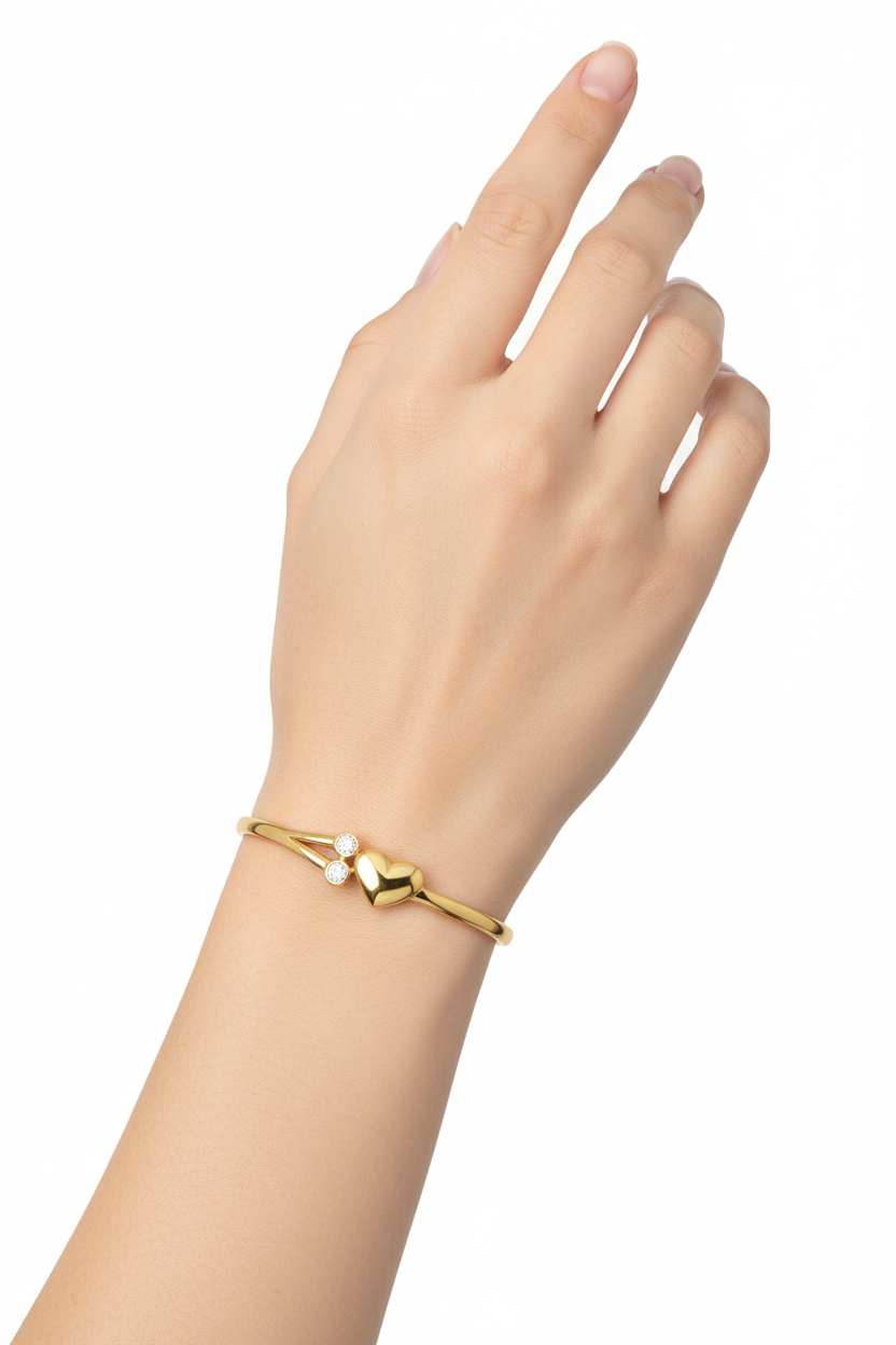 Pulseira dourada com coração e brilhantes no pulso