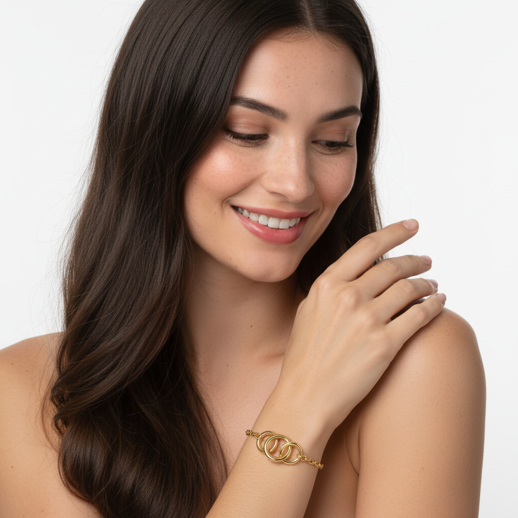 Pulseira dourada com três anéis entrelaçados no pulso de mulher