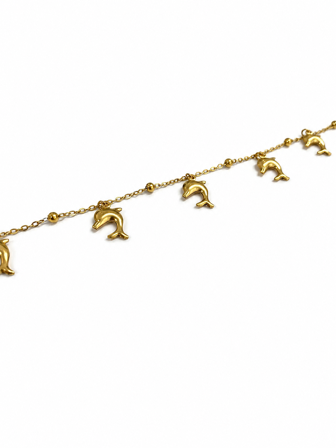 Pulseira dourada com pingentes de golfinho