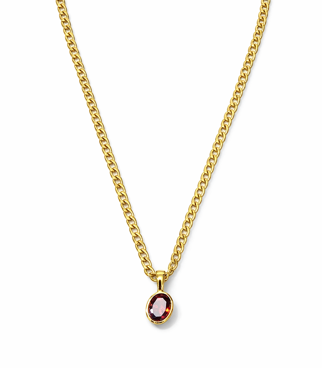 Colar dourado com pendente de pedra vermelha oval
