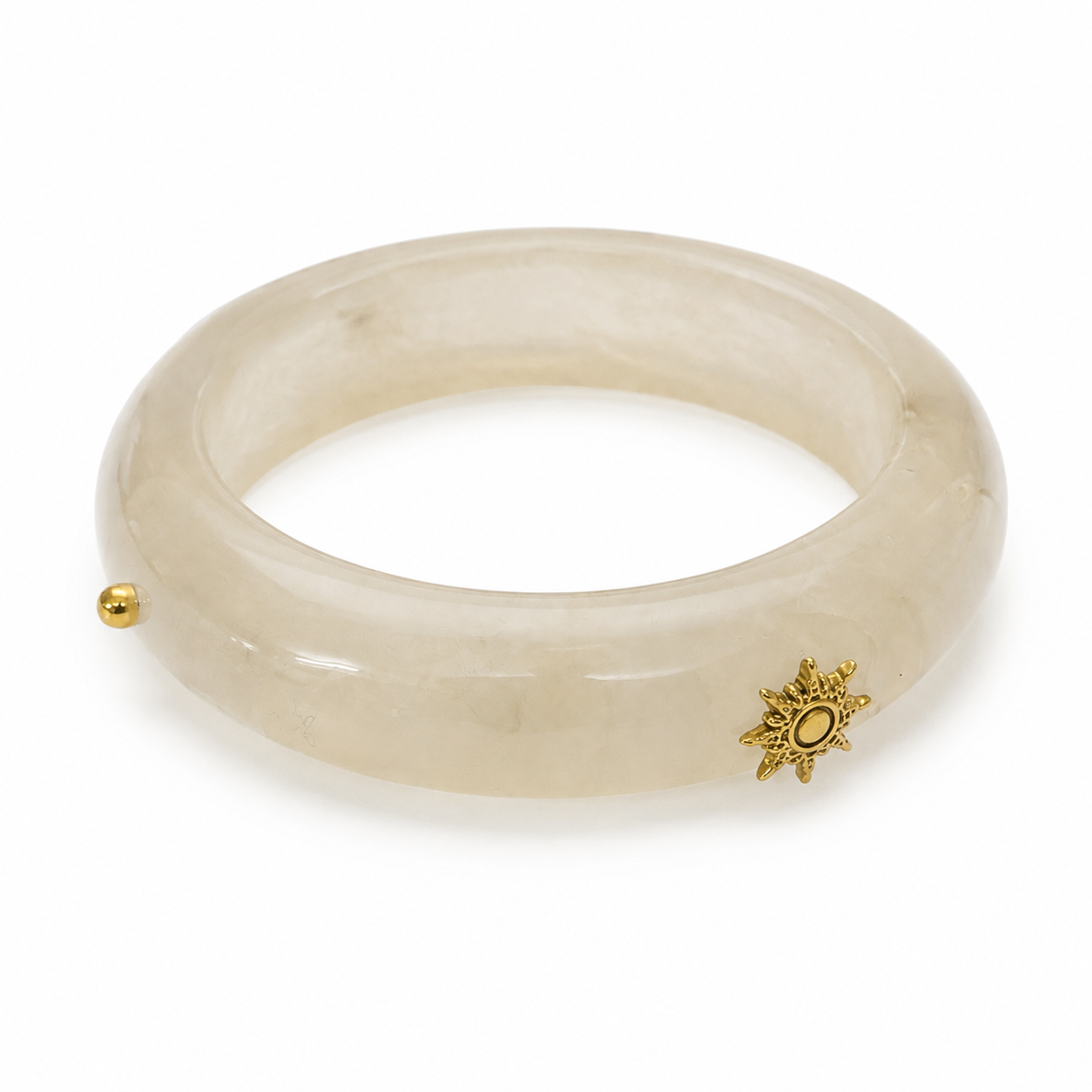 Pulseira rígida bege com detalhes dourados e ornamento em forma de sol