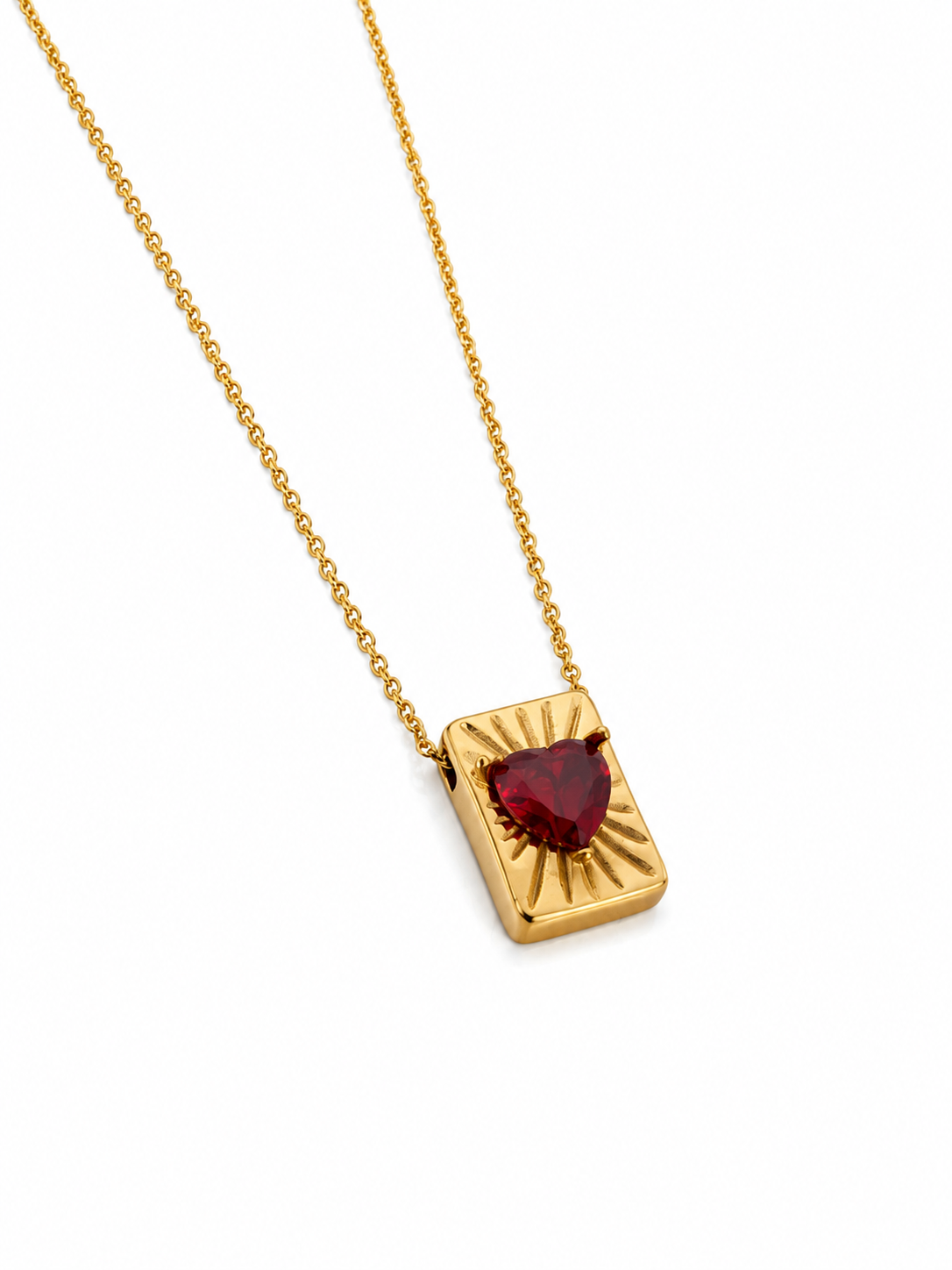 Colar dourado com pendente retangular e cristal vermelho em forma de coração