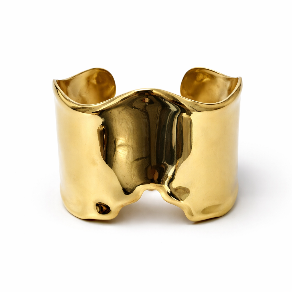 Pulseira larga em metal dourado com superfície ondulada