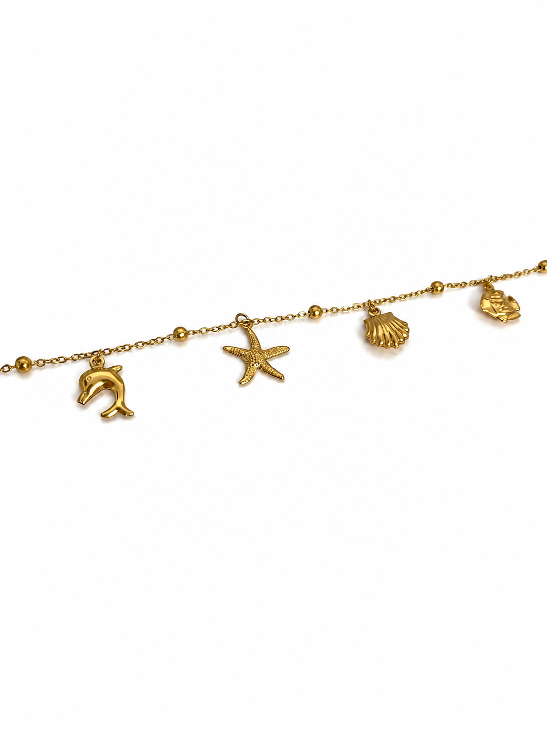 Pulseira dourada com pendentes marinhos em fundo branco