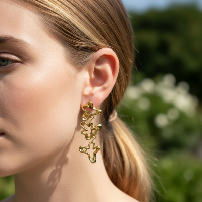 Brincos dourados em forma de aviões pendentes no ouvido de mulher com cabelo apanhado