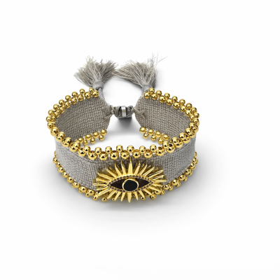 Pulseira cinzenta com contas douradas e pendente em forma de olho